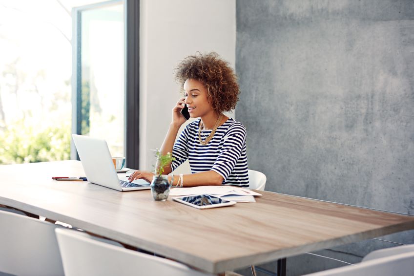 woman on the phone at her desk