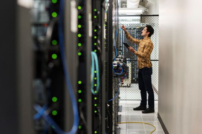 Man checking data center connections