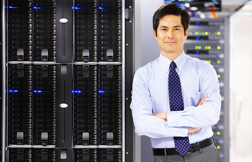 businessman leans confidently on servers