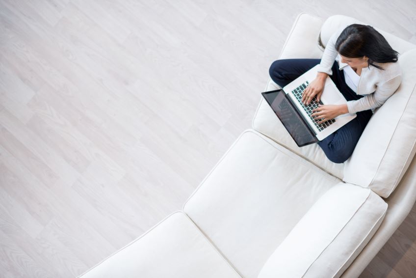 woman sitting on couch on laptop