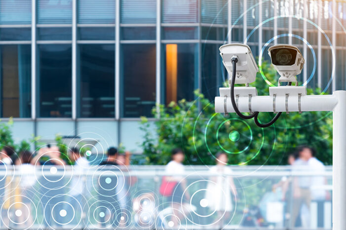 Smart city image with security cameras signaling data.