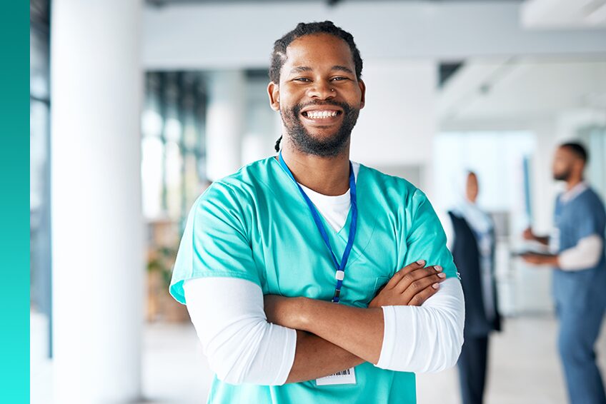 A healthcare worker crosses their arms and smiles